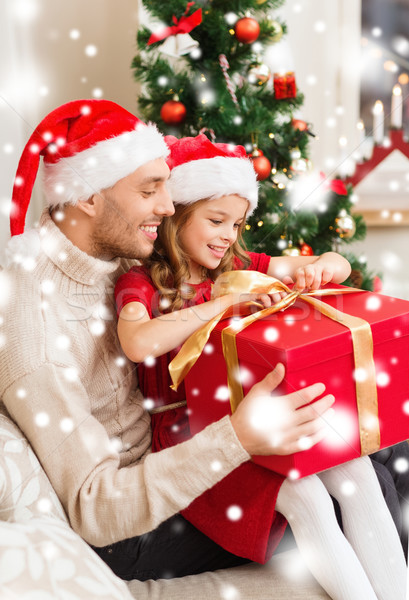 smiling father and daughter opening gift box Stock photo © dolgachov