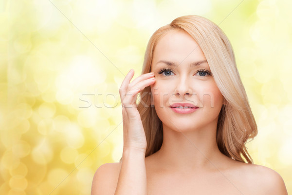 beautiful woman touching her eye area Stock photo © dolgachov