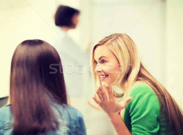 student girl gossiping in lecture at school Stock photo © dolgachov