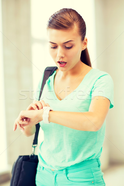 surprised student girl looking at clock Stock photo © dolgachov