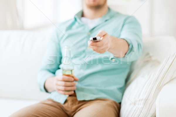 Stock photo: man with beer and remote control at home