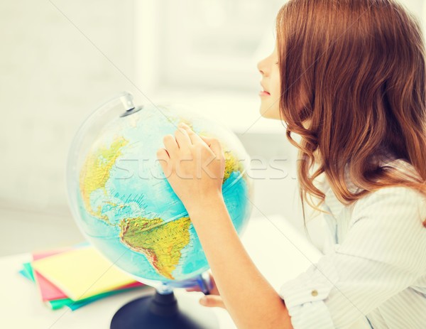 curious student girl with globe at school Stock photo © dolgachov