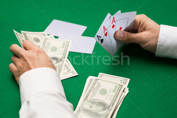 poker player with cards and money at casino Stock photo © dolgachov