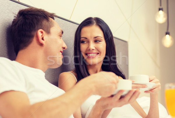 smiling couple having breakfast in bed in hotel Stock photo © dolgachov