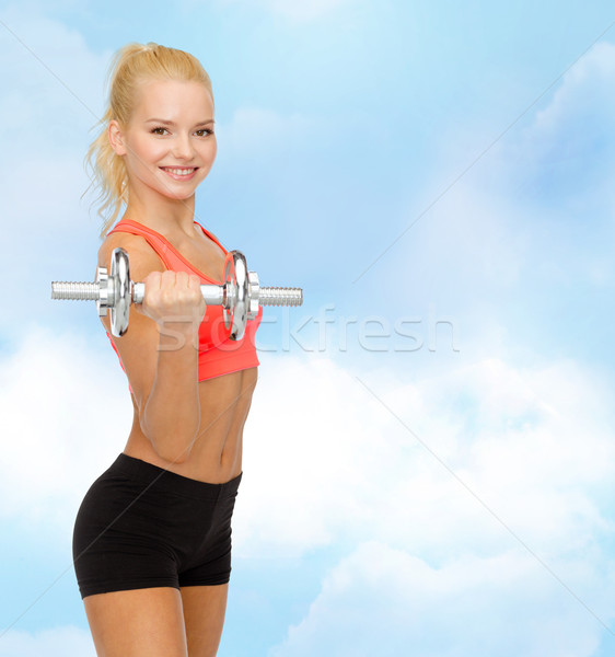 young sporty woman with heavy steel dumbbell Stock photo © dolgachov