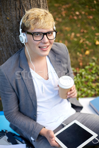 happy teenage boy in headphones with tablet pc Stock photo © dolgachov