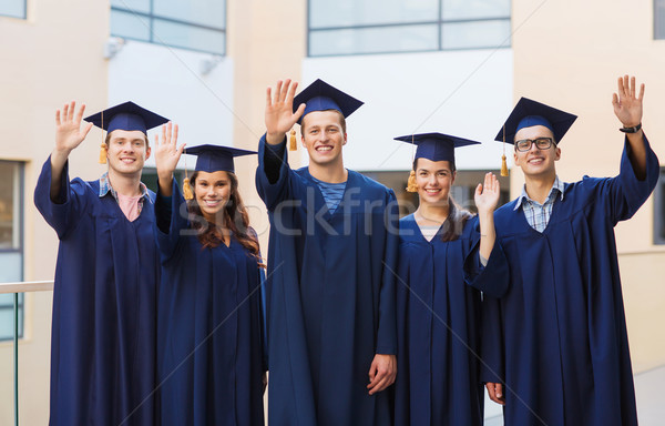 group of smiling students in mortarboards Stock photo © dolgachov
