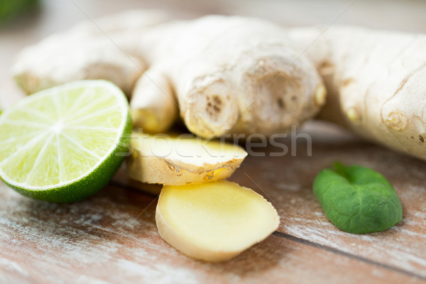 close up of ginger root and lime on wooden table Stock photo © dolgachov