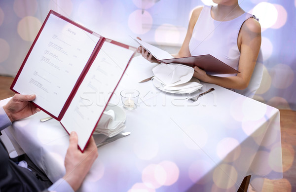 close up of couple with menu at restaurant Stock photo © dolgachov