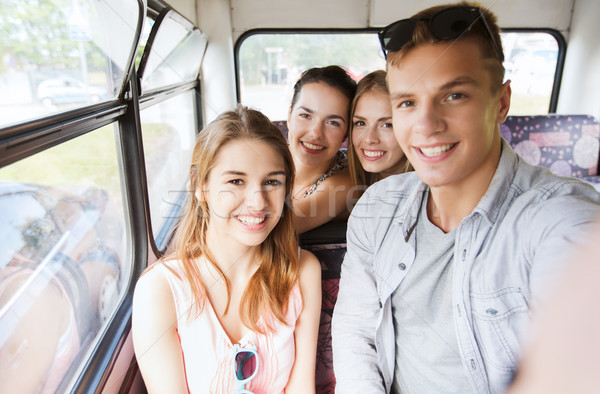 happy teenage friends traveling by bus Stock photo © dolgachov
