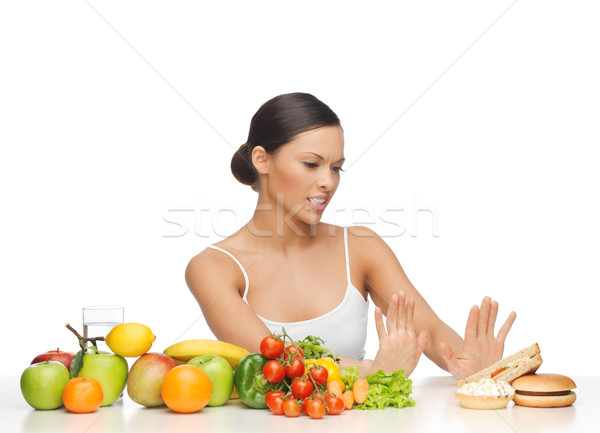 woman with fruits rejecting hamburger Stock photo © dolgachov