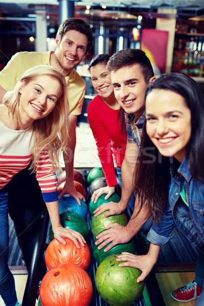 happy friends in bowling club Stock photo © dolgachov