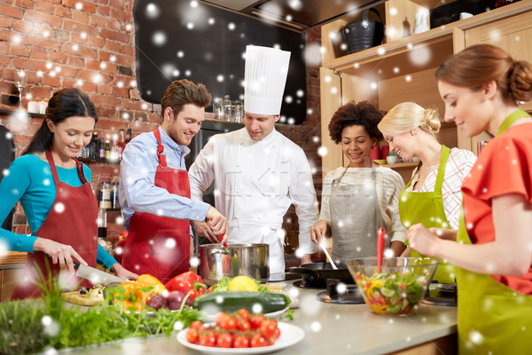 Stock photo: happy friends and chef cook cooking in kitchen
