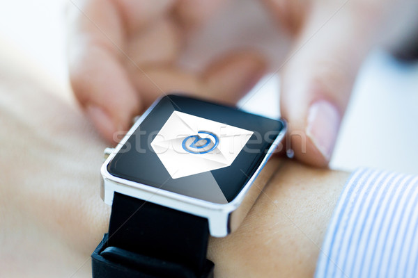close up of hands with email icon on smartwatch Stock photo © dolgachov