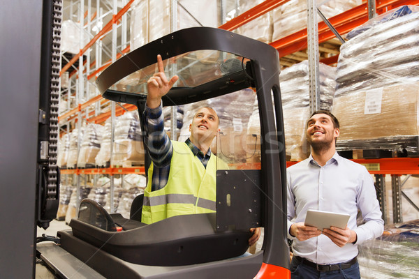 men with tablet pc and forklift at warehouse Stock photo © dolgachov