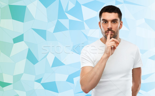 man making hush sign over low poly background Stock photo © dolgachov