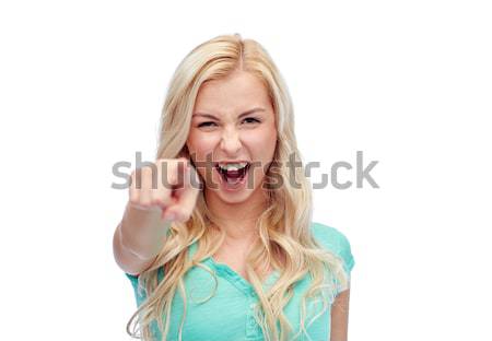 Szczęśliwy młoda kobieta wskazując palec gest emocje Zdjęcia stock © dolgachov
