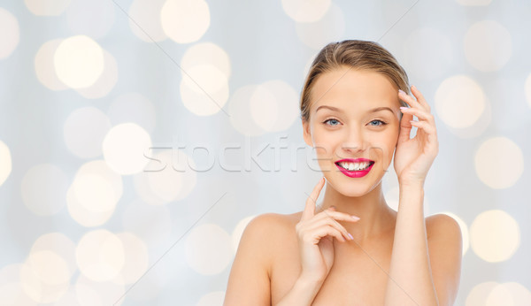 smiling young woman with pink lipstick on lips Stock photo © dolgachov