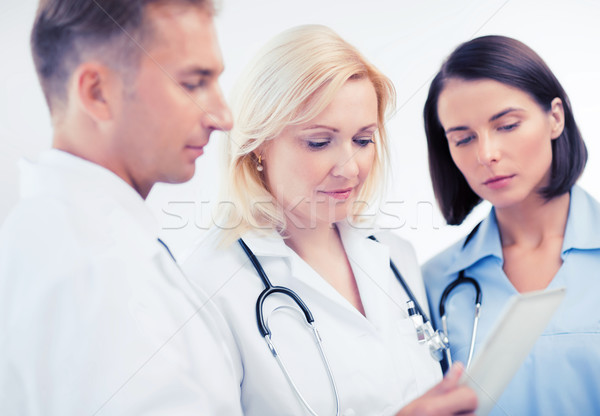 Stock photo: doctors looking at tablet pc