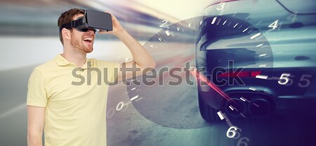 man in virtual reality headset and car racing game Stock photo © dolgachov