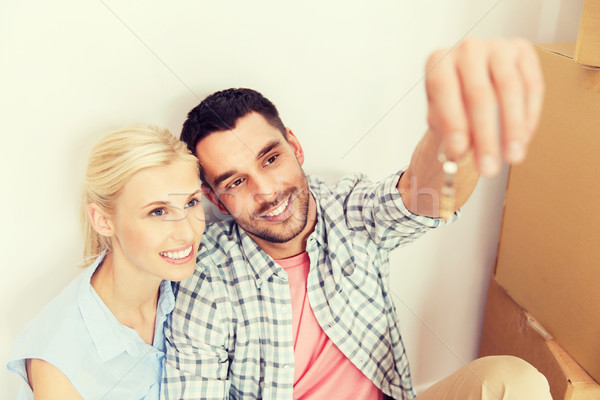 couple with key and boxes moving to new home Stock photo © dolgachov