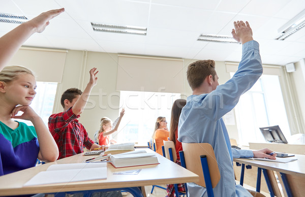 group of students with raised hands at high school Stock photo © dolgachov