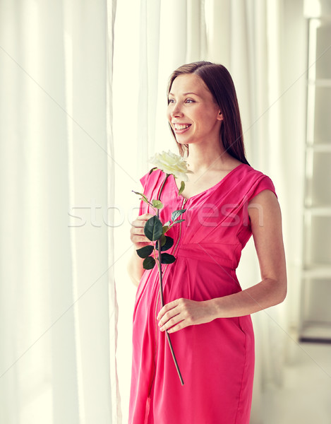 happy pregnant woman with rose flower at home Stock photo © dolgachov