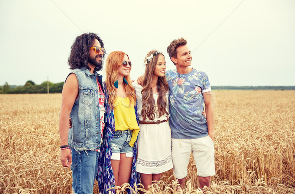 smiling young hippie friends on cereal field Stock photo © dolgachov