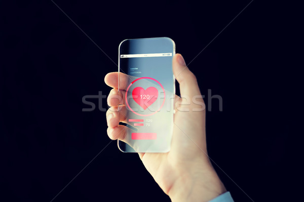 close up of hand with smartphone measuring pulse Stock photo © dolgachov