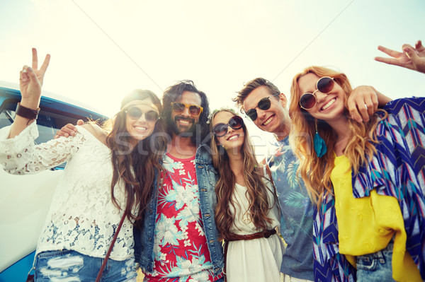 Stock photo: hippie friends over minivan car showing peace sign