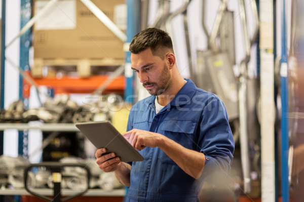 auto mechanic or smith with tablet pc at workshop Stock photo © dolgachov