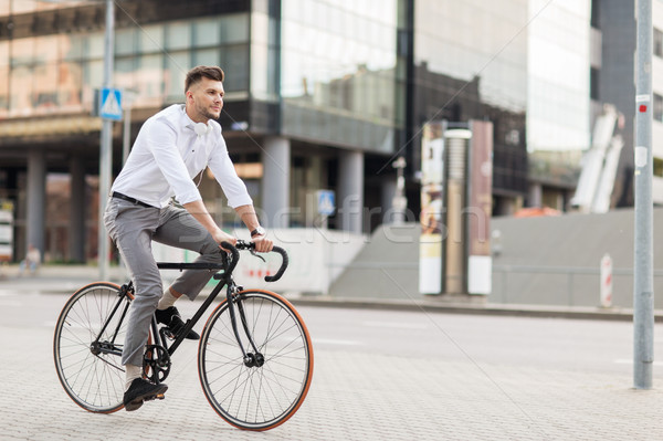 man with headphones riding bicycle on city street Stock photo © dolgachov