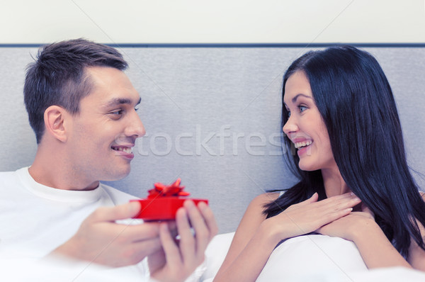 man giving woman little red gift box Stock photo © dolgachov