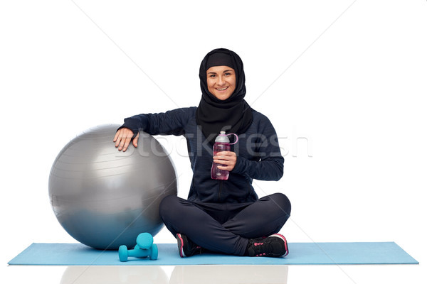 muslim woman in hijab with fitness ball and bottle Stock photo © dolgachov
