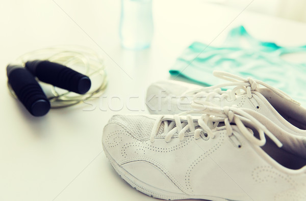 close up of sportswear, skipping rope and bottle Stock photo © dolgachov