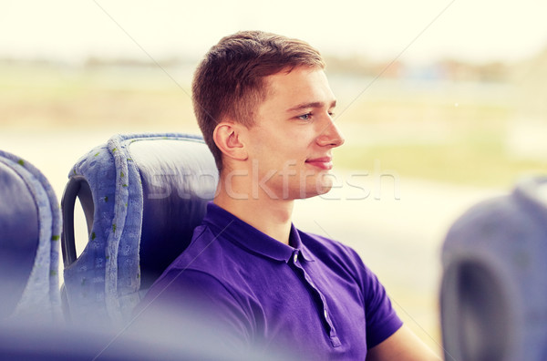 Szczęśliwy młody człowiek posiedzenia podróży autobus pociągu Zdjęcia stock © dolgachov