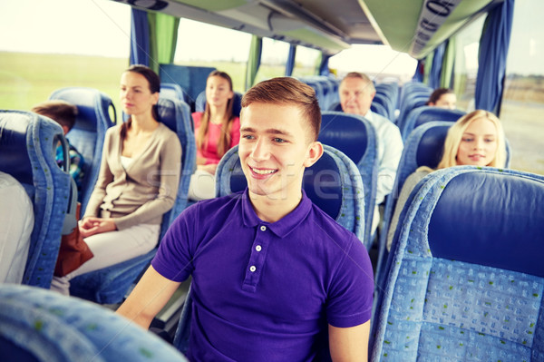 happy young man sitting in travel bus or train Stock photo © dolgachov