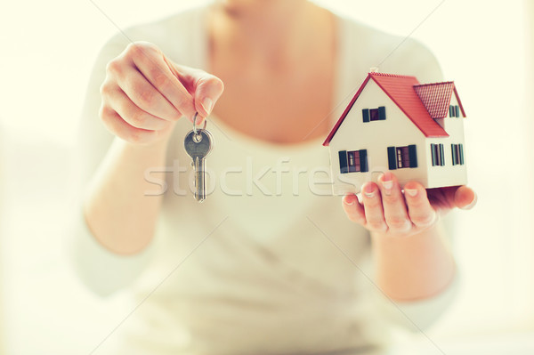 close up of hands holding house model and keys Stock photo © dolgachov