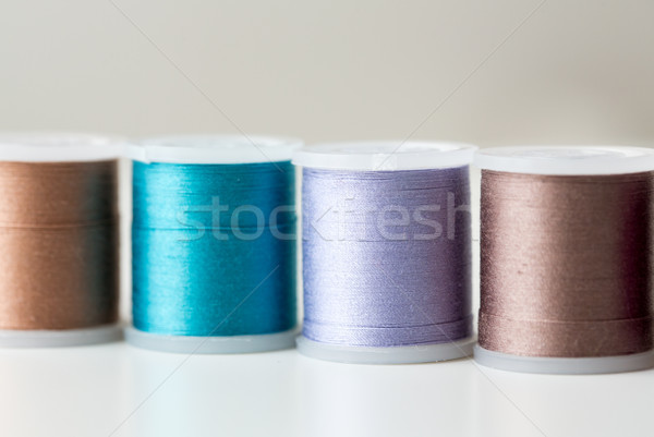 row of colorful thread spools on table Stock photo © dolgachov