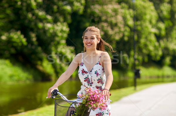 Stock photo: happy woman riding fixie bicycle in summer park