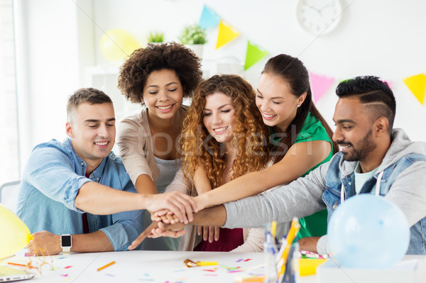 Stock photo: happy team at office party holding hands together