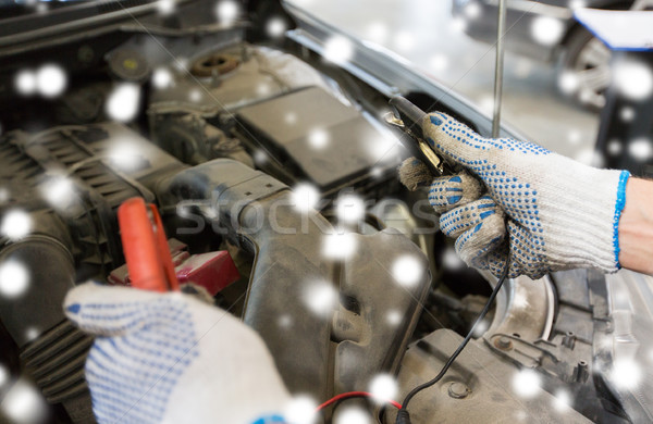 auto mechanic hands with cleats charging battery Stock photo © dolgachov