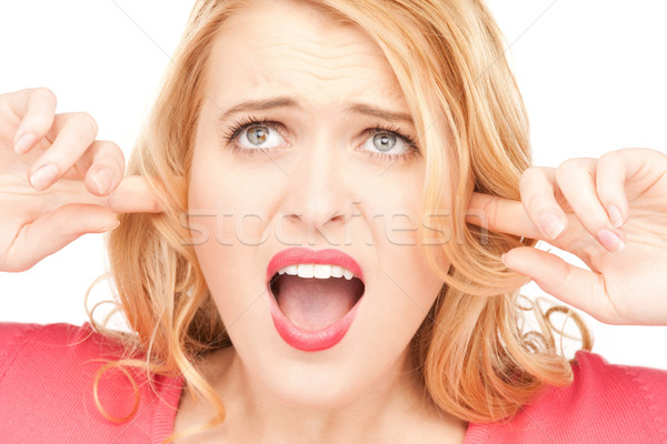 woman with fingers in ears Stock photo © dolgachov