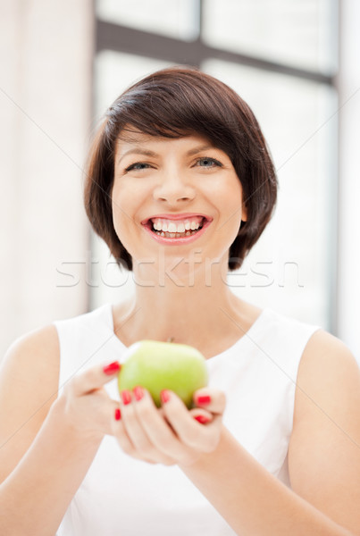 lovely housewife with green apple Stock photo © dolgachov