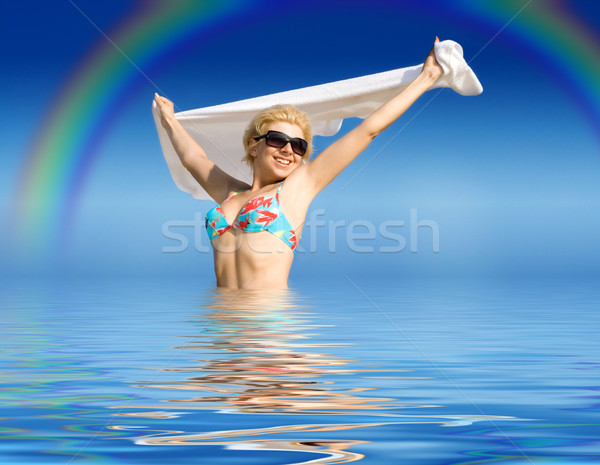 happy girl with towel standing in water Stock photo © dolgachov