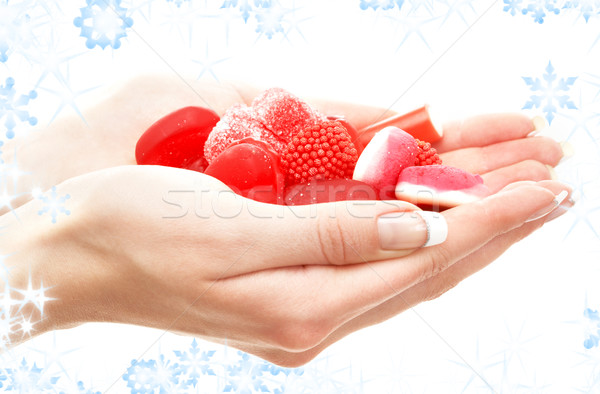 hands full of red bonbons Stock photo © dolgachov