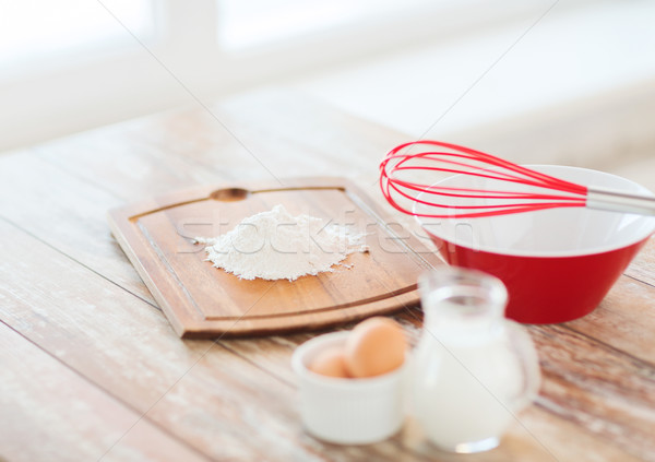 jugful of milk, eggs in a bowl and flour Stock photo © dolgachov