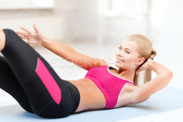 Stock photo: sporty woman doing exercise on the floor
