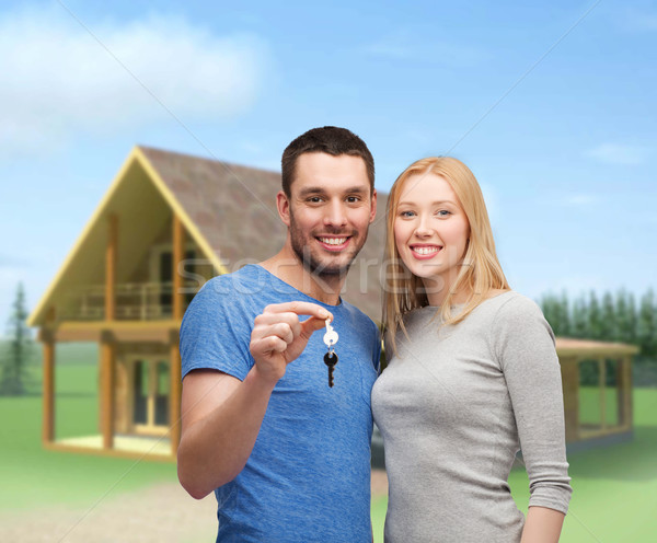 Glimlachend paar sleutels onroerend familie Stockfoto © dolgachov