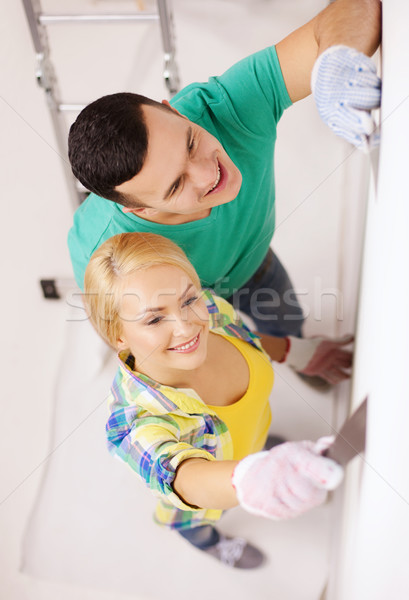 smiling couple doing renovations at home Stock photo © dolgachov